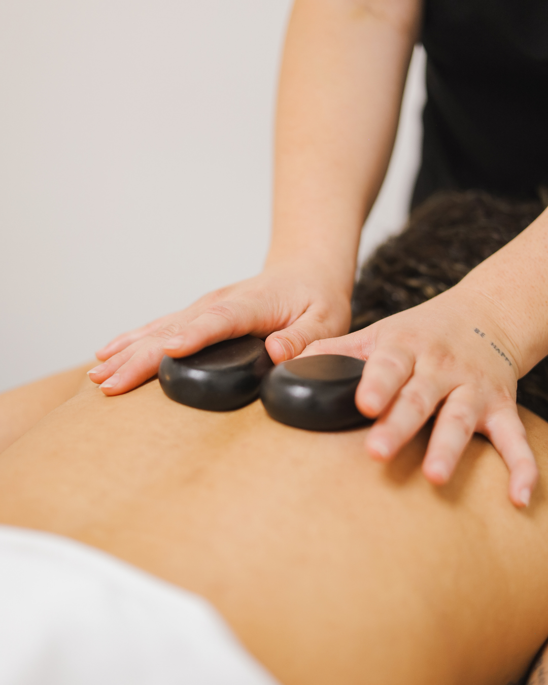 Woman receiving a relaxing professional massage therapy session at a wellness clinic, highlighting different massage techniques and their benefits.